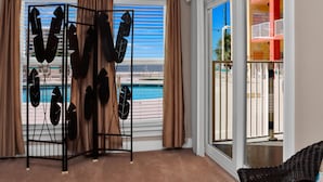 A room with a view of a pool and a balcony. - Paradise Shores 105 (Port St. Joe)