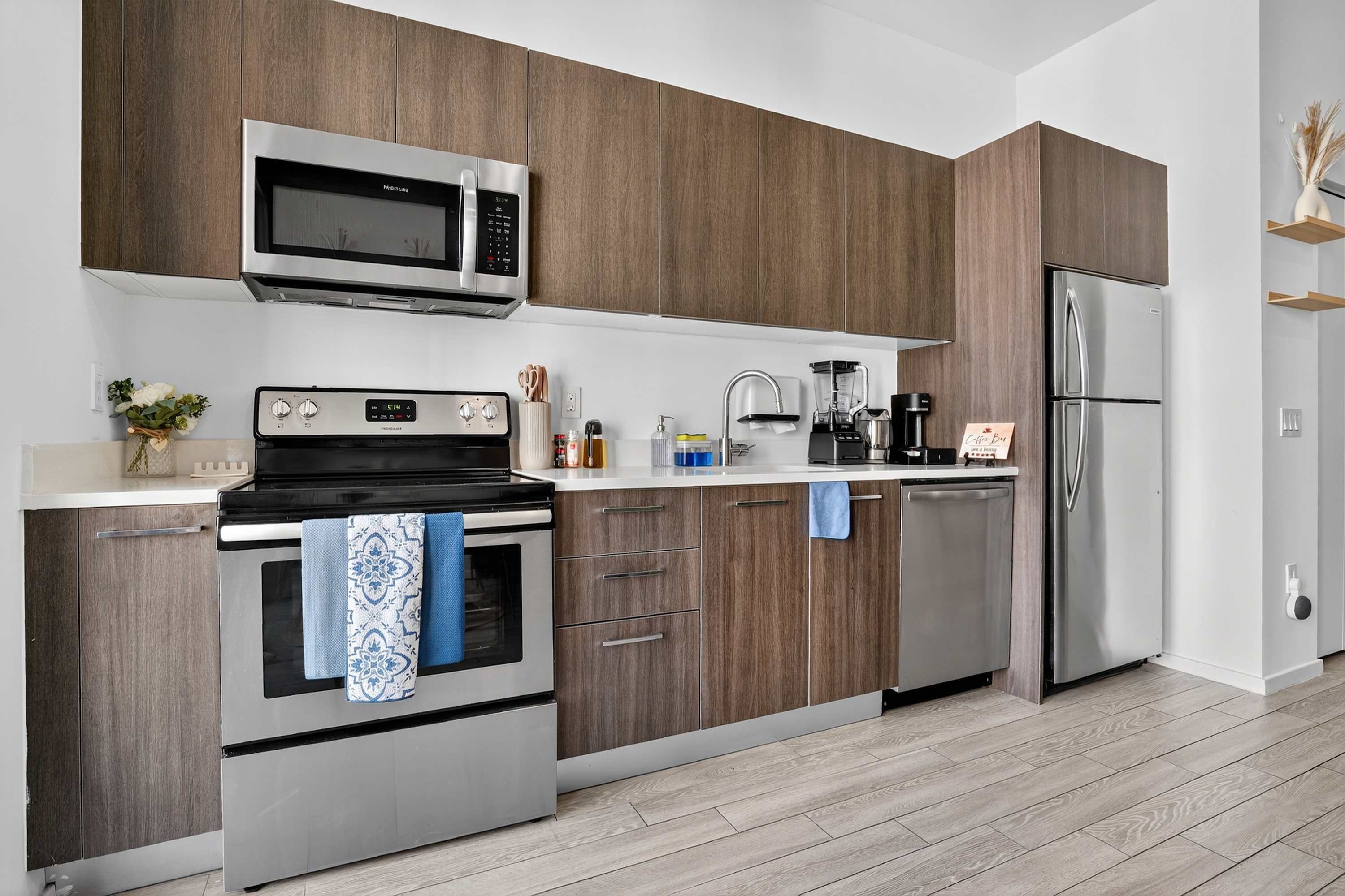 A modern kitchen with wooden cabinets, stainless steel appliances, and a clean layout.