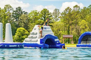 An inflatable water slide with a person climbing it.