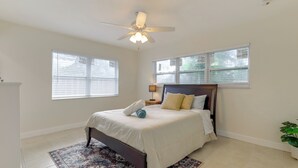 A bedroom with a bed, a ceiling fan, and two windows with blinds. - 1 Mi to Sand! Deerfield Beach Home w/ Patio (Deerfield Beach)