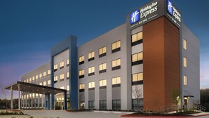 A Holiday Inn Express hotel with a modern design, featuring a covered entrance and multiple windows.