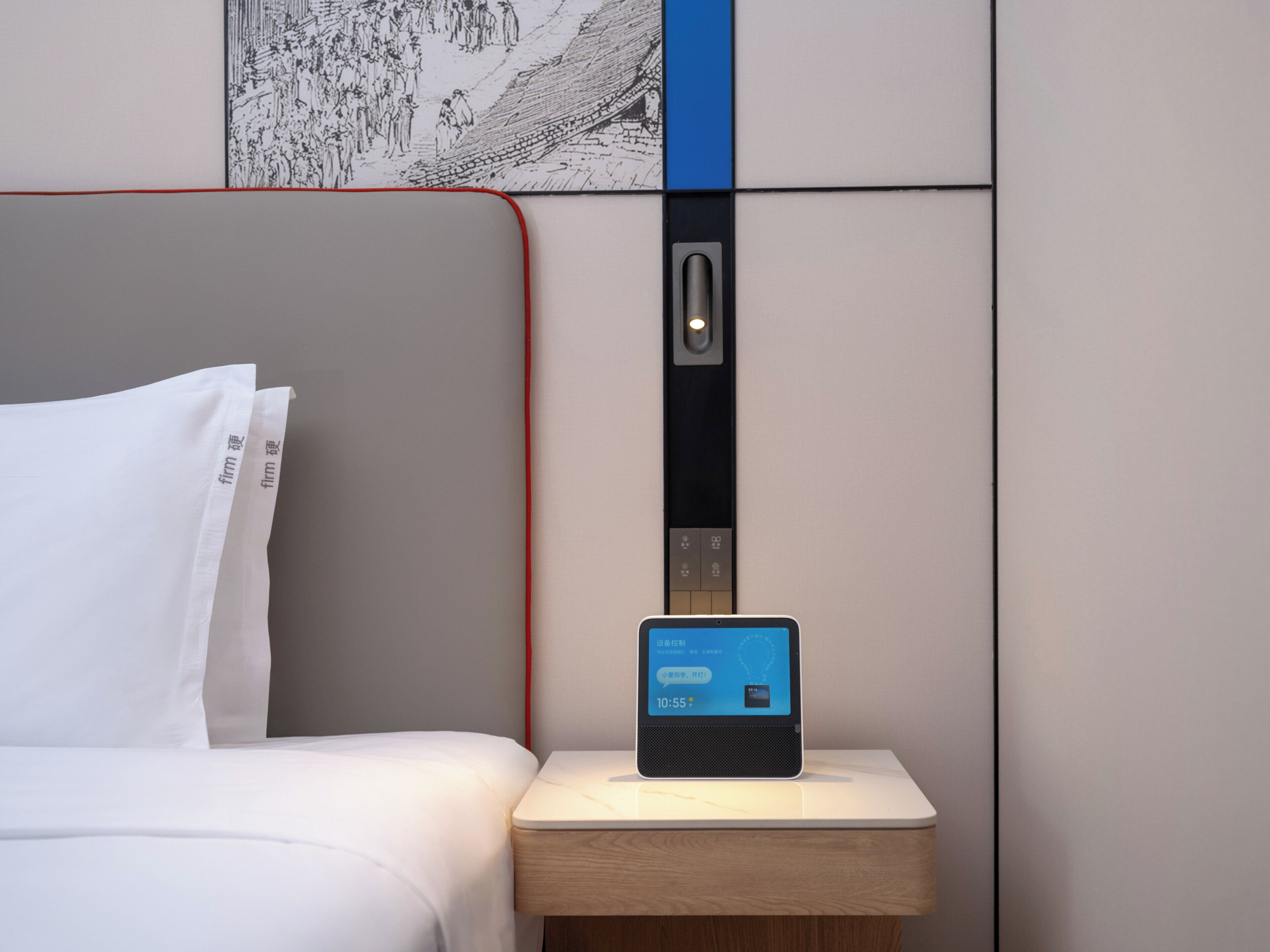 A hotel room with a bed, a nightstand with a digital clock, and a wall-mounted elevator.