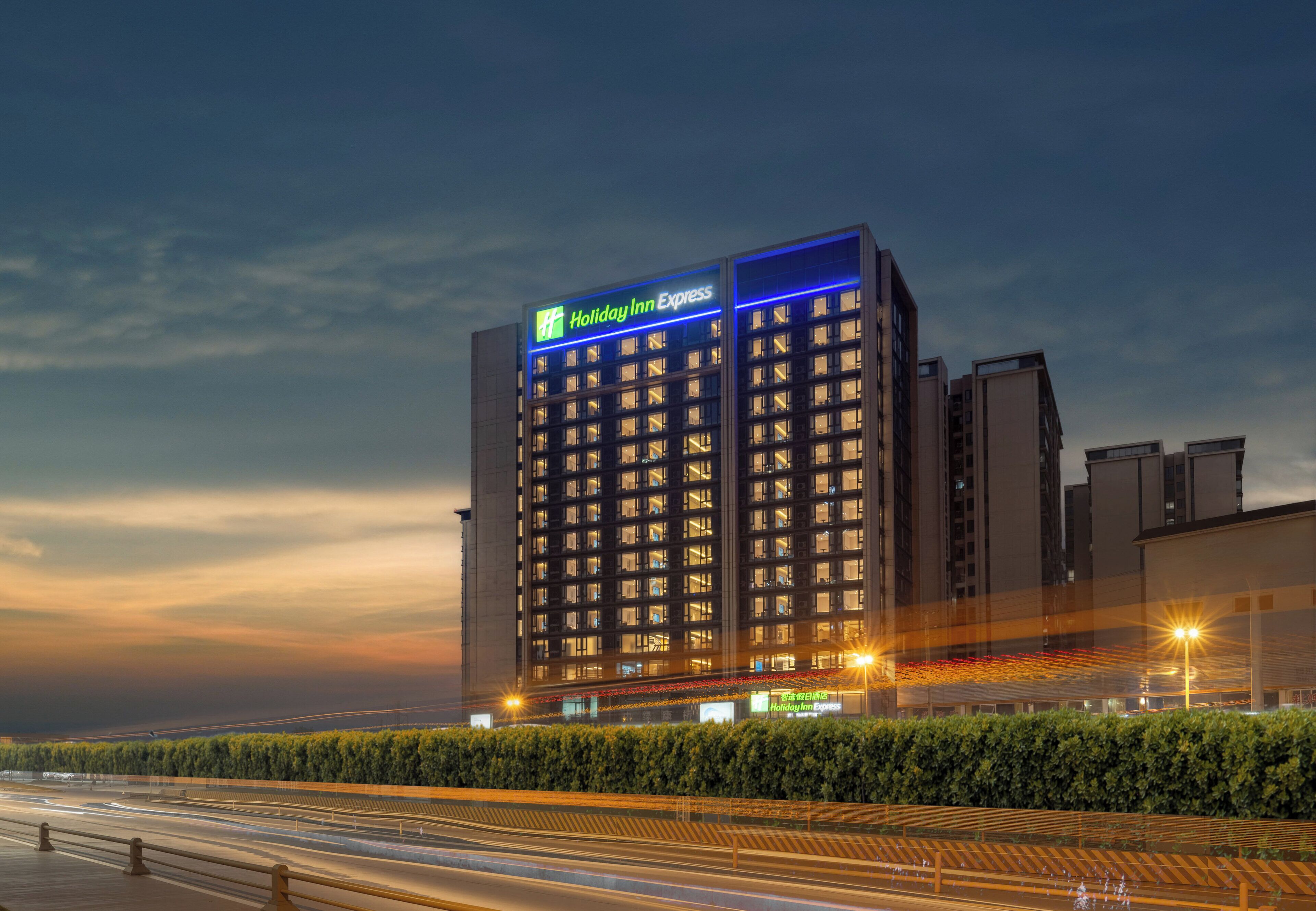 A Holiday Inn Express hotel with a modern design, featuring a prominent sign at the top.
