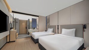 A modern hotel room with two beds, a flat-screen TV, a desk with a coffee maker, and a bathroom visible through a door. - Holiday Inn Express Chengdu Shuangliu Chuanda Road by IHG (Chengdu)