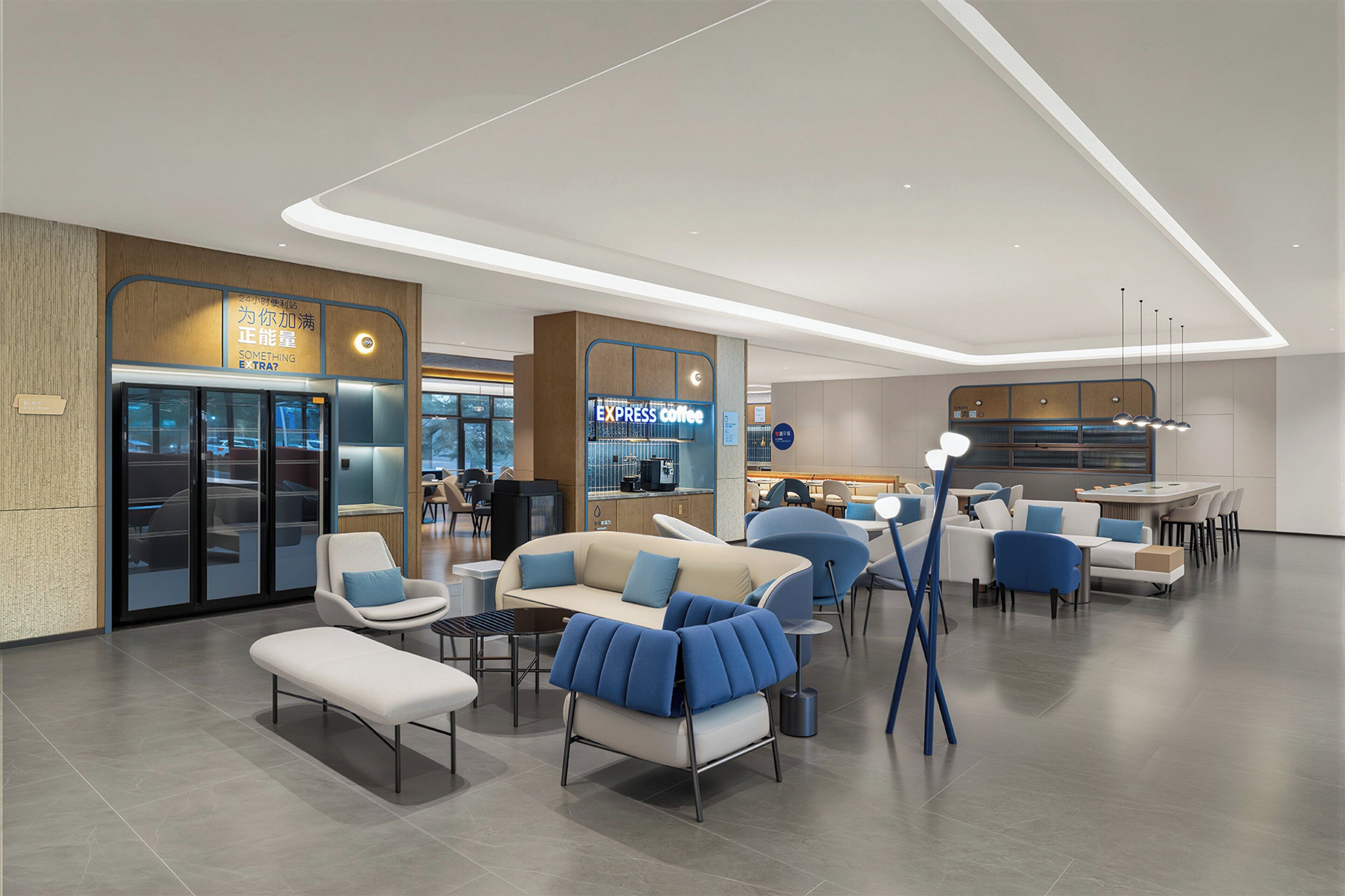 A modern lounge area with seating, a coffee bar, and a glass door entrance.