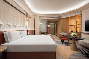 A modern hotel room with a large bed, a seating area with a table, and a TV. - Hotel Indigo Xi An High Tech Zone by IHG (Xi'an)
