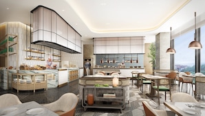 A modern restaurant with a central bar, seating areas, and a view of the city. - Holiday Inn Qingdao CBD by IHG (Qingdao)