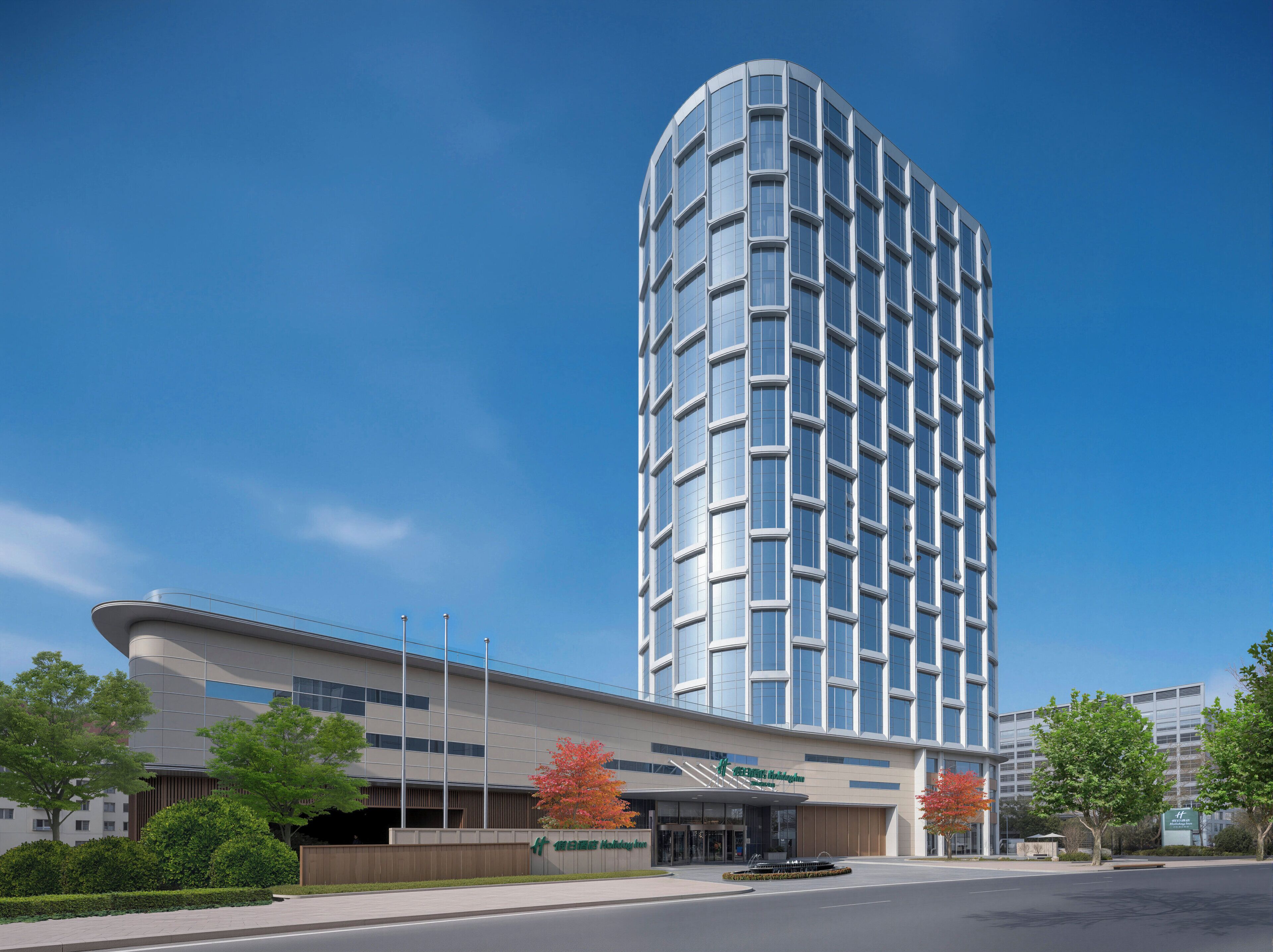 A modern hotel with a curved facade, large windows, and a prominent entrance.