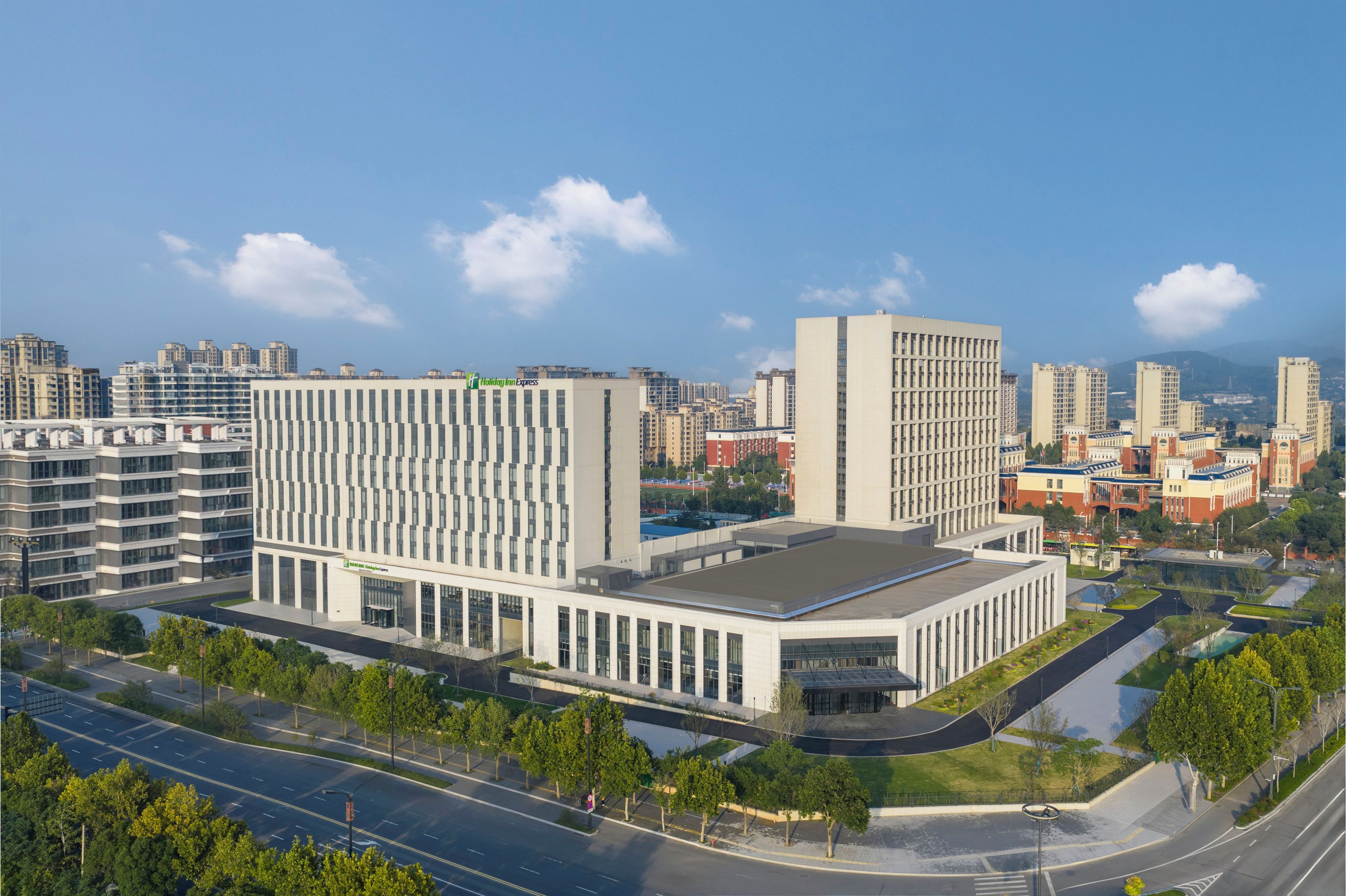 A modern building with a rectangular layout, large windows, and a flat roof.