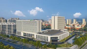 A modern building with a rectangular layout, large windows, and a flat roof.