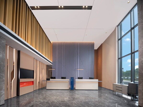 A modern reception area with a high ceiling, large windows, and a reception desk. - Holiday Inn Express Gongyi City Center by IHG (Zhengzhou)