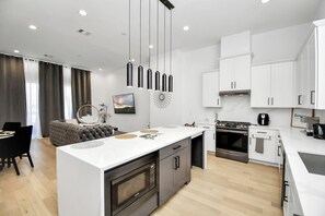 Bright, seamless flow between the kitchen, dining, and main living space. - Downtown Houston 3BR  Home with Rooftop, Spa tub  (Houston)