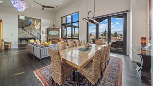 A spacious dining area with a large wooden table, wicker chairs, and a patterned rug. - Park City Lighthouse| Mountain View, Hot Tub & BBQ (Park City)