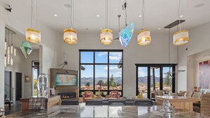 A spacious living room with a large marble table, comfortable seating, and a fireplace. - Park City Lighthouse| Mountain View, Hot Tub & BBQ (Park City)