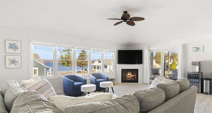 Modern-coastal retreat with lake views, covered deck, and walkable downtown Beulah location.