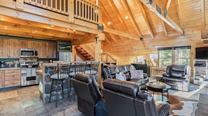 A spacious log cabin interior with a kitchen, dining area, and seating area. - Forest Views, Hot Tub & Fireplace Minutes From Breckenridge Shangri-la Cabin by Avantstay (Breckenridge)