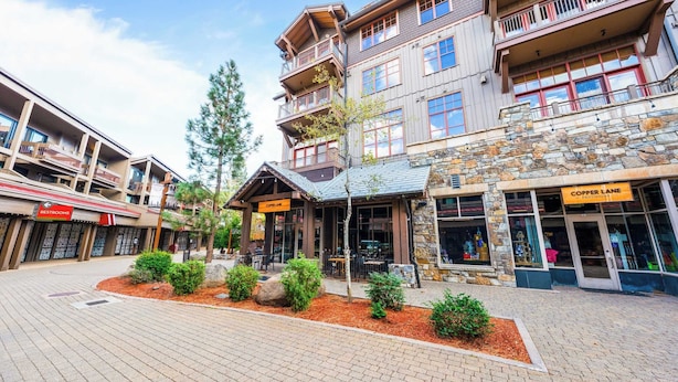 A building with multiple floors, a stone facade, and a sign for 'Copper Lane Provisions'. - Cozy Northstar Village Escape w/ Forest Views & Easy Lift Access Alpineglow Vista by Avantstay (Truckee)