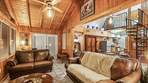 A cozy log cabin interior with a living room, dining area, and kitchen. - 3-bedroom cabin in gorgeous Clermont with AC (Clermont)