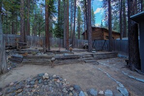 A rustic cabin surrounded by tall pine trees. - Private Woods - Heavenly California Lodge (South Lake Tahoe)