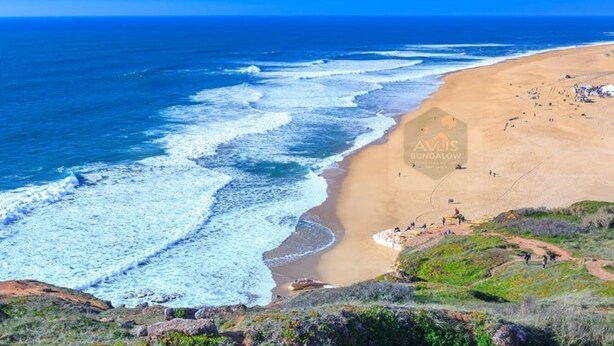 A beach with a bungalow named Nature's Avlis Bungalow 4XZ.