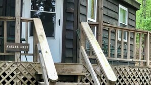 A wooden staircase leading to a porch with a sign reading 'Eagles Nest.' - Eagle’s Nest Cabin • Private Forest Stay (Caddo Gap)
