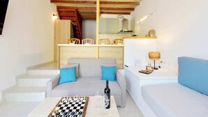 A cozy living room with a chessboard, a sofa, and a dining area with chairs and a table. - LiRi - Family paradise (Ialysos)