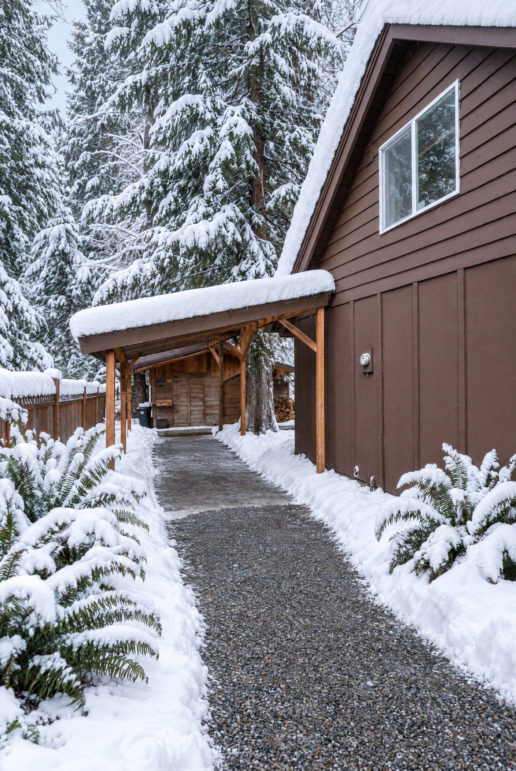 Covered carport and gravel path to the cabin