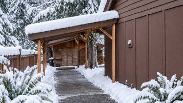 Covered carport and gravel path to the cabin