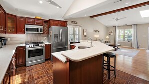 A spacious kitchen with a large island, built-in appliances, and a high ceiling with skylights. - 3 Bedroom Family Retreat in Ocean Pines! (Ocean Pines)