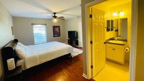 A bedroom with a bed, a ceiling fan, a television, and a window. - Private Pool •Near Boat Docks •Historic DT•Beaches (Saint Augustine South)