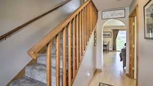 A staircase with wooden railings leading to a landing. A 'Welcome' sign is visible on the wall. - Paradise Found Condo with Stunning Mountain Views located in Paradise Valley, MT (Emigrant)