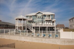 A multi-story beachfront house with a pool, a gazebo, and a staircase leading to the upper levels. - Bellissimo - Oceanfront with Pool, Hot Tub, Theater Room, Elevator, Game Tables (Virginia Beach)