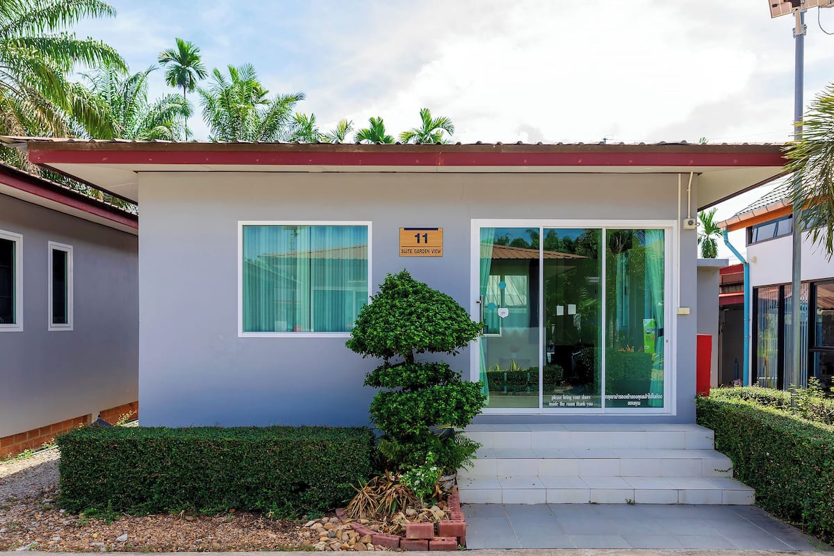 A building with a sign indicating "Suite Garden View" and a number "11".