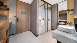A modern bathroom with a large mirror, a sink, and a shower area. - BEIJING JIASHIDE HOTEL (Tongzhou)