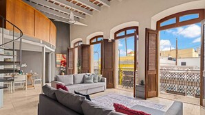 Un espacio habitable amplio con sofá, mesa de comedor y zona de cocina.