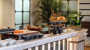 A buffet setup with various food items and serving utensils. - METT Singapore (Singapore)