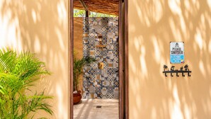 A pathway leading to a pool area with a sign instructing to shower before entering. - Villa Tres Delfines Private Pool And Family Fun Puerto Aventuras (Puerto Aventuras)