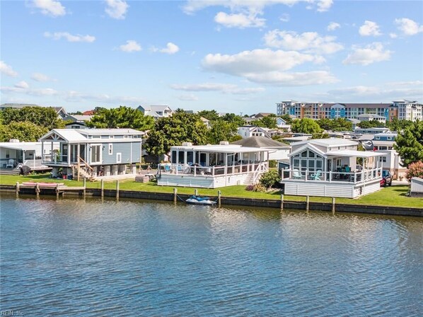 A waterfront property with multiple houses, docks, and a calm lake.