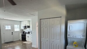 A modern kitchen with white cabinets, a microwave, and a built-in oven.