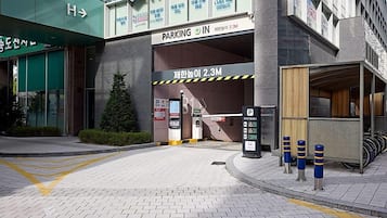 A parking garage entrance with a sign indicating a height limit of 2.3 meters.