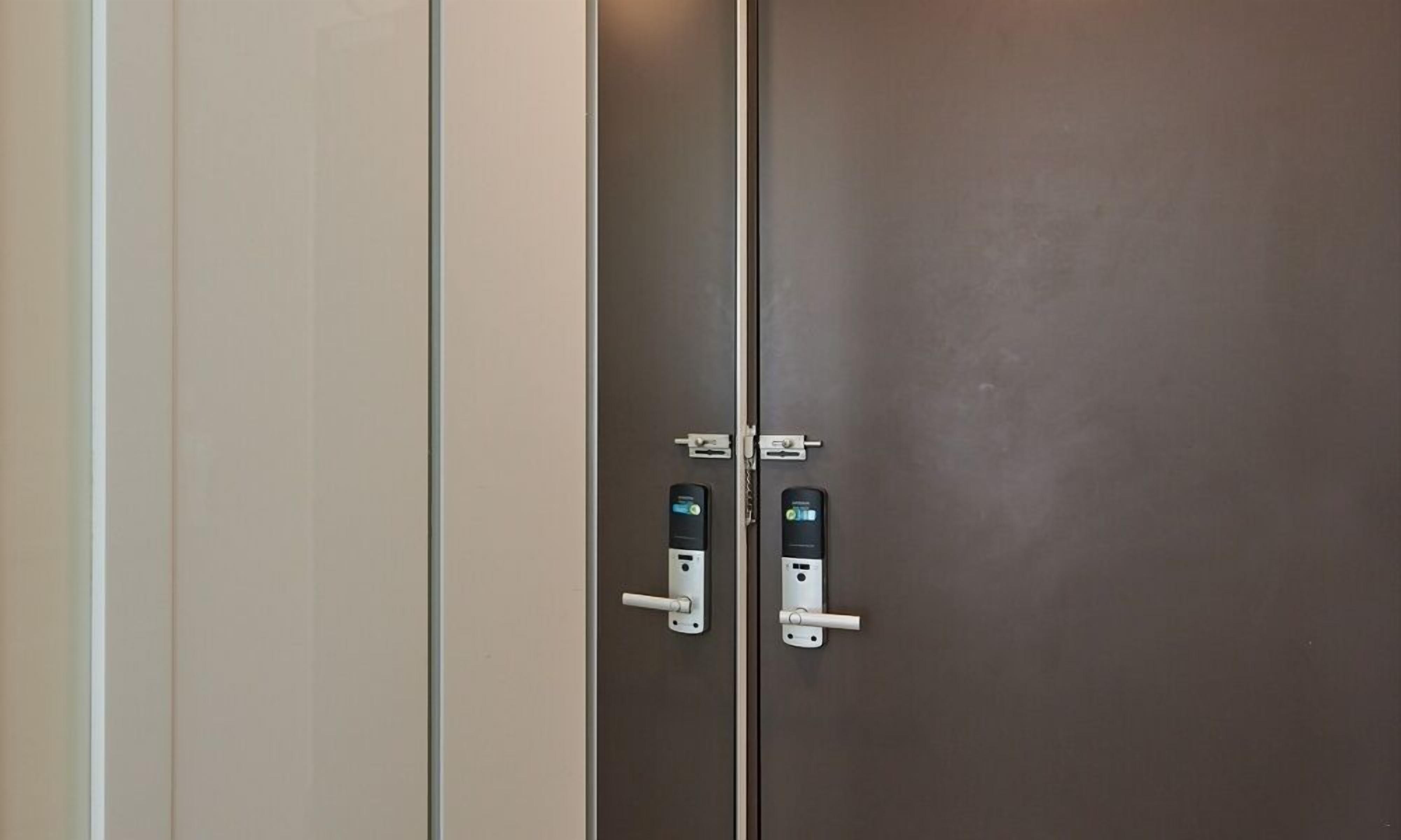 A set of double doors with electronic locks and a keyhole.