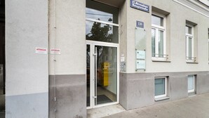En bygning med et skilt der viser "17. Hernalser Hauptstraße" og en dør med teksten "ATTENSAM".