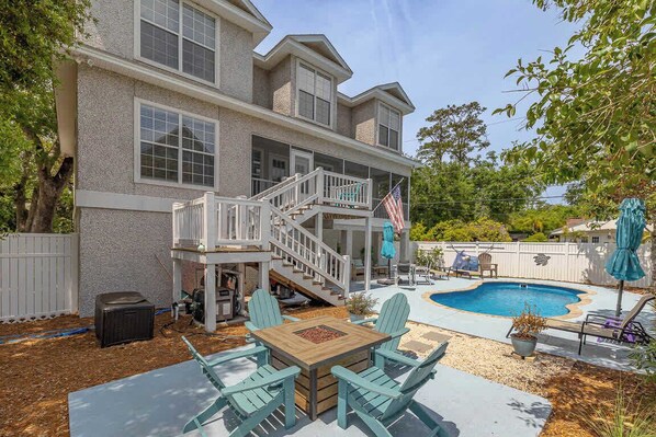A two-story house with a backyard swimming pool, outdoor seating area, and a covered patio. - Relax and Unwind in Sunny St. Simons! Private Pool + Outdoor Oasis! (St. Simons Island)