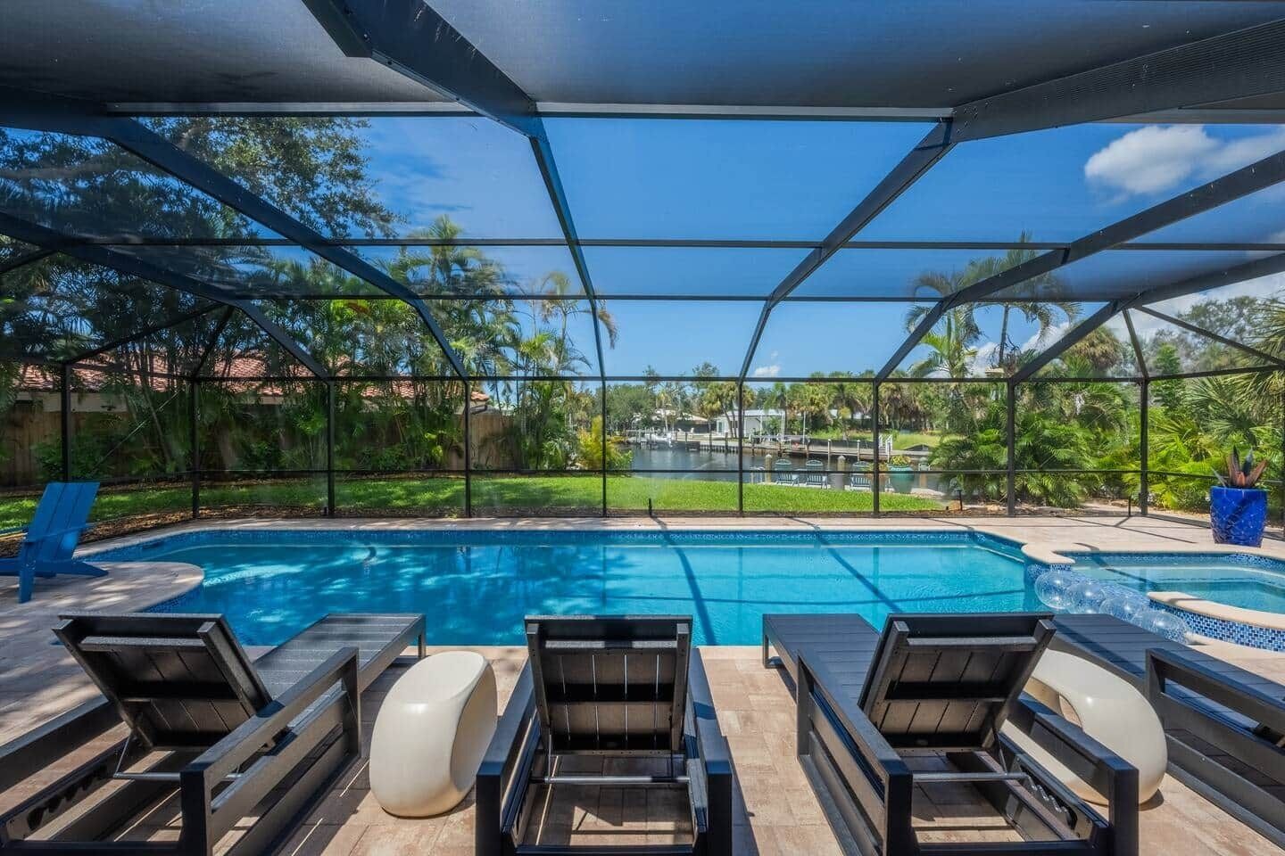 Your private screened pool with canal views beyond. Swim, float, repeat.