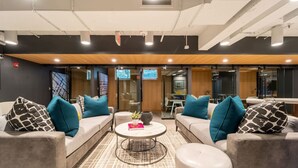 A modern lounge area with sofas, a coffee table, and a TV screen. - Elevated Minimalist Escape, Free Parking & Metro (Arlington)