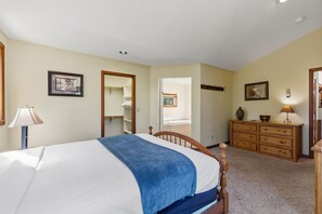 A bedroom with a bed, dresser, and a mirror. - Breckenridge Basecamp | Hot Tub + Fire Pit (Breckenridge)