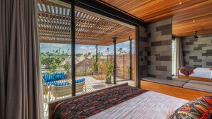 A bedroom with a large bed, a view of the outdoors, and a wooden ceiling.