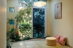 Japanese-style Double Room | Living area | 80-inch Smart TV with cable channels, fireplace - Home. Homestay (Hanoi)