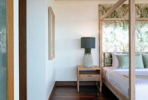 A bedroom with a bed, a nightstand with a lamp, and a wooden headboard. -  Katamanda Villa Allegra 5BR Seaview villa Kata (Karon)
