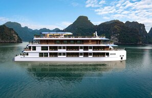 A multi-deck cruise ship with a modern design, featuring multiple balconies and a logo that reads "DU YEN CRUISE". - Du Yen Cruise (Tuan Chau)